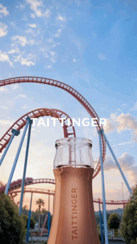 Animated Taittinger bottle erupting into a cascade of white foam against a fairground roller coaster backdrop — cgi advertising Thinkdiff, photography & art direction by Floow, produced by Thinkdiff AI Production House